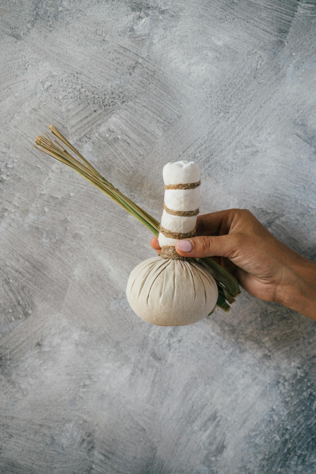 Hot herbal compress therapy with Thai herbs